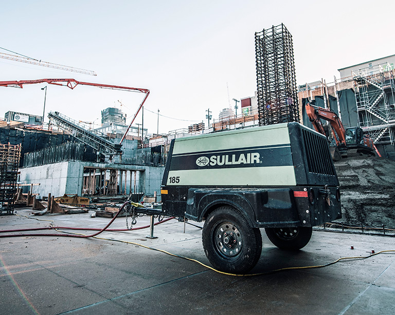 Sullair 185 portable diesel air compressor at a job site